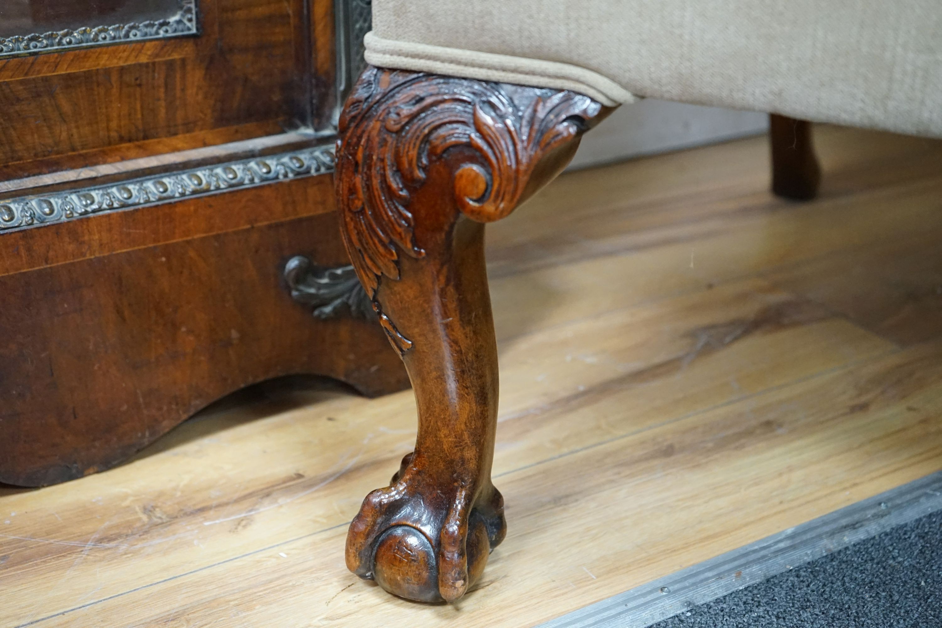 A heavy large upholstered wing armchair, width 92cm, depth 90cm, height 126cm